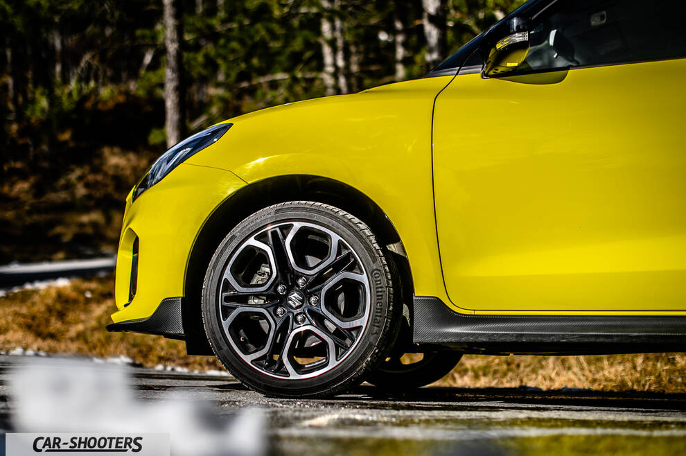 Suzuki Swift Sport – side profile, yellow against a mountain backdrop