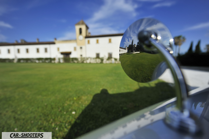 Jaguar XK 120 – detail, retro side mirror close-up with historic building background