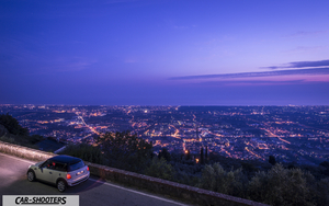Mini Cooper S Pietrasanta Retina – rear three-quarter, white against a city view backdrop