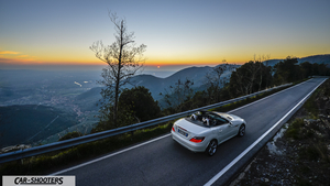 Mercedes Benz SLK – rear three-quarter, white against a mountain backdrop