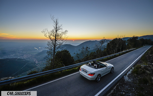 Mercedes Benz SLK – rear three-quarter, white against a sunset mountain backdrop