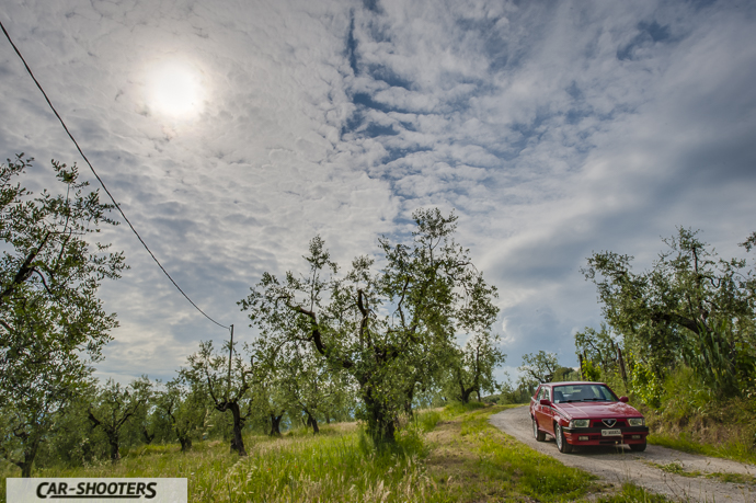 Alfa Romeo 75 – front three-quarter, red on a country road