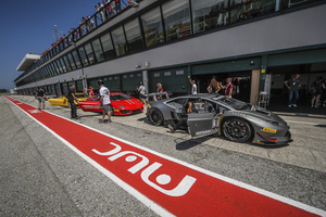 front three-quarter, grey at a race track pit lane