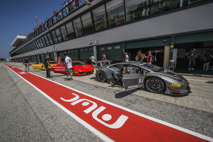front three-quarter, grey at a race track pit lane