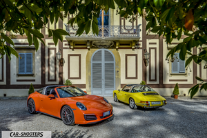 Porsche 911 Targa Storica – front three-quarter, orange in front of a historic building