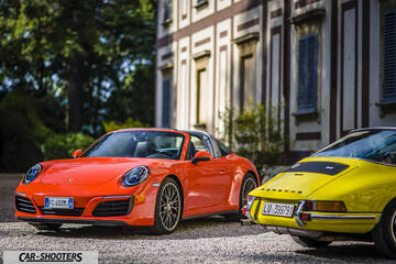 Porsche 911 Targa Storica – front three-quarter, bright orange in front of an old building