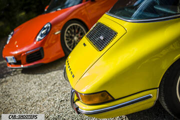 Porsche 911 Targa Storica – rear three-quarter, yellow on a gravel surface