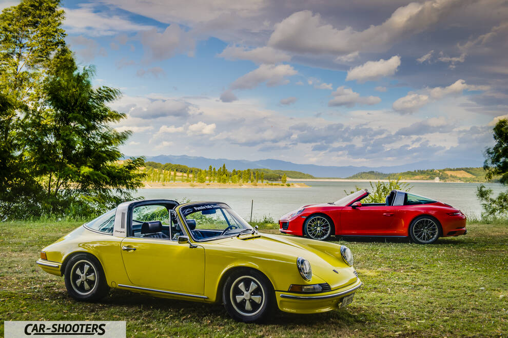 Porsche 911 Targa Storica – front three-quarter, yellow against a scenic lake backdrop