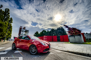 Alfa Romeo Mito Veloce Imola Mugello – front three-quarter, red against a dramatic sky background