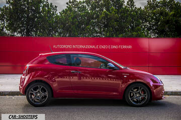 Alfa Romeo Mito Veloce Imola Mugello – side profile, red against a red wall backdrop