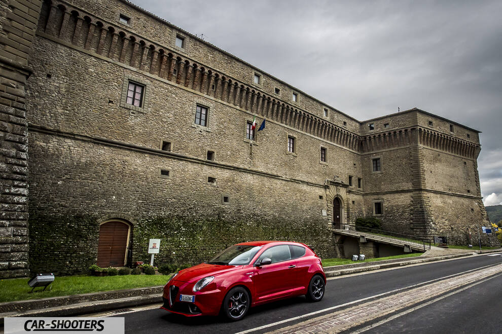 Alfa Romeo Mito Veloce Imola Mugello – front three-quarter, red against a stone castle wall