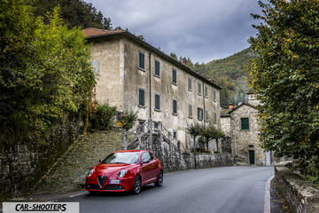 Alfa Romeo Mito Veloce Imola Mugello – front three-quarter, red on a narrow village road