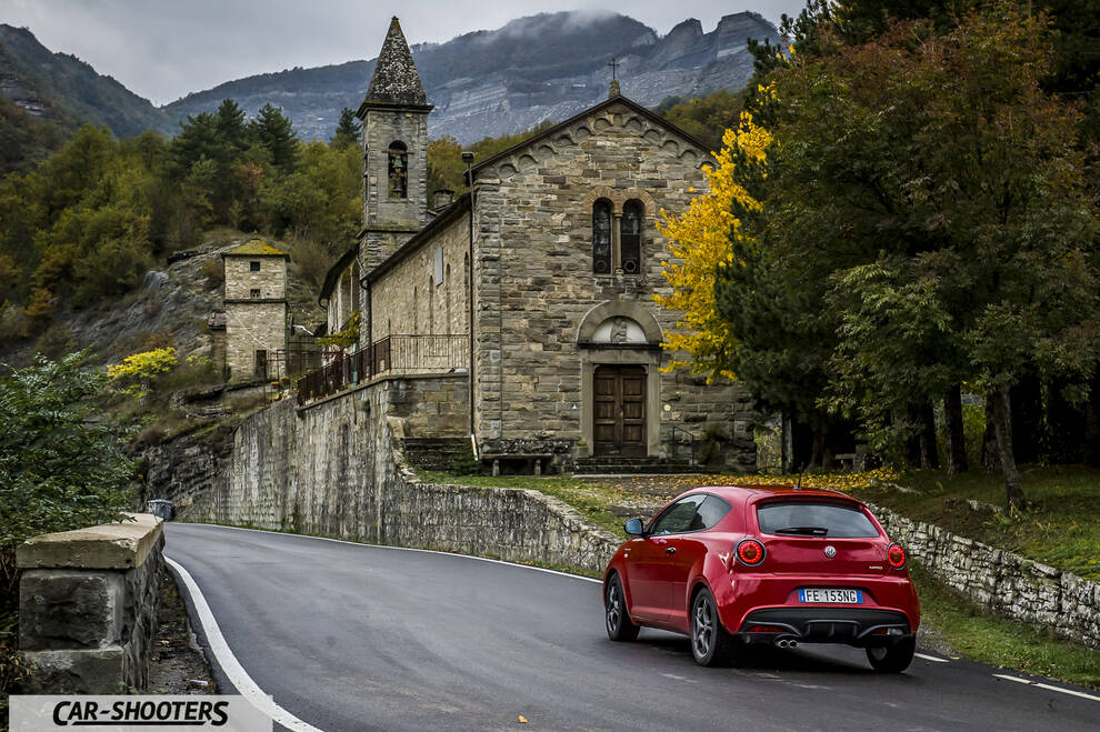 Alfa Romeo Mito Veloce Imola Mugello – rear three-quarter, red on a road near a stone church