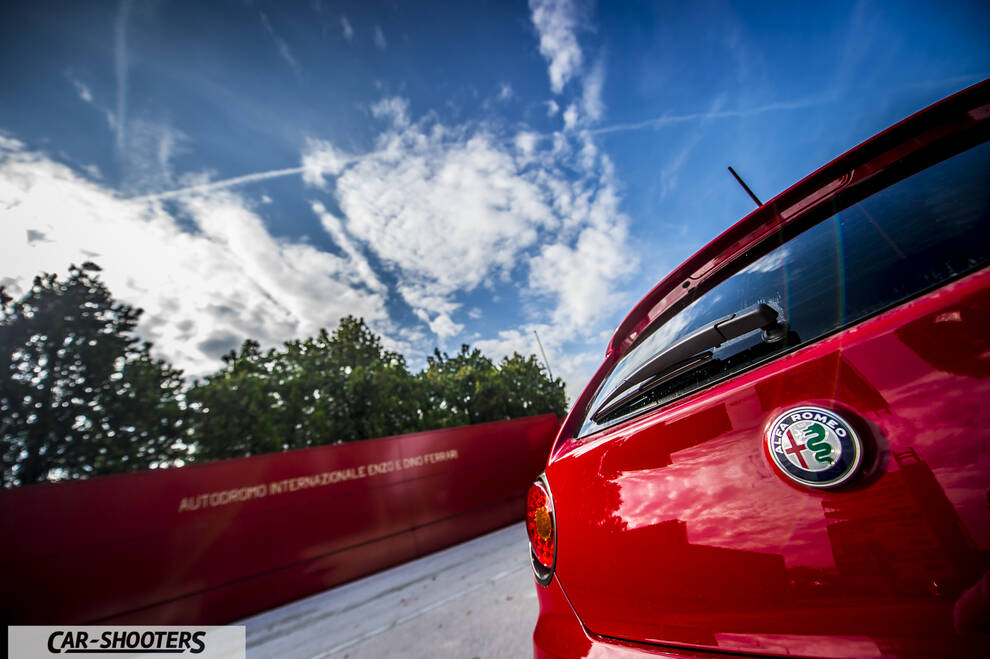 Alfa Romeo Mito Veloce Imola Mugello – rear three-quarter, red against a racetrack backdrop