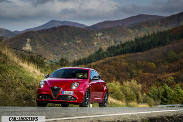 Alfa Romeo Mito Veloce Imola Mugello &ndash; front three-quarter, red against a mountain backdrop