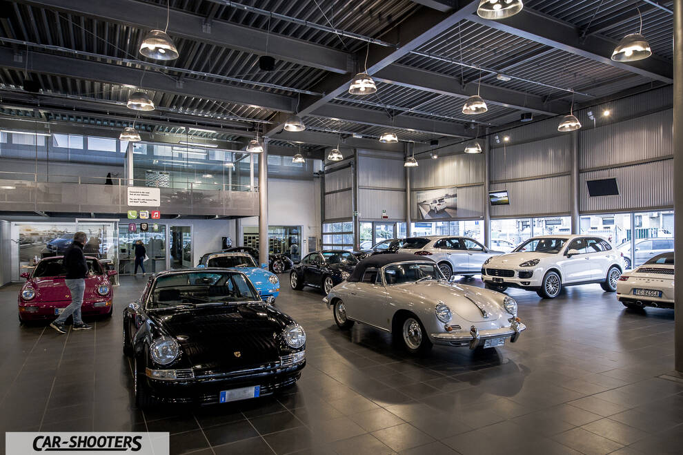 Porsche – front three-quarter, black in a car showroom