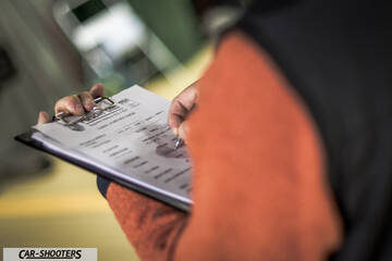 Porsche – detail, person writing on a clipboard