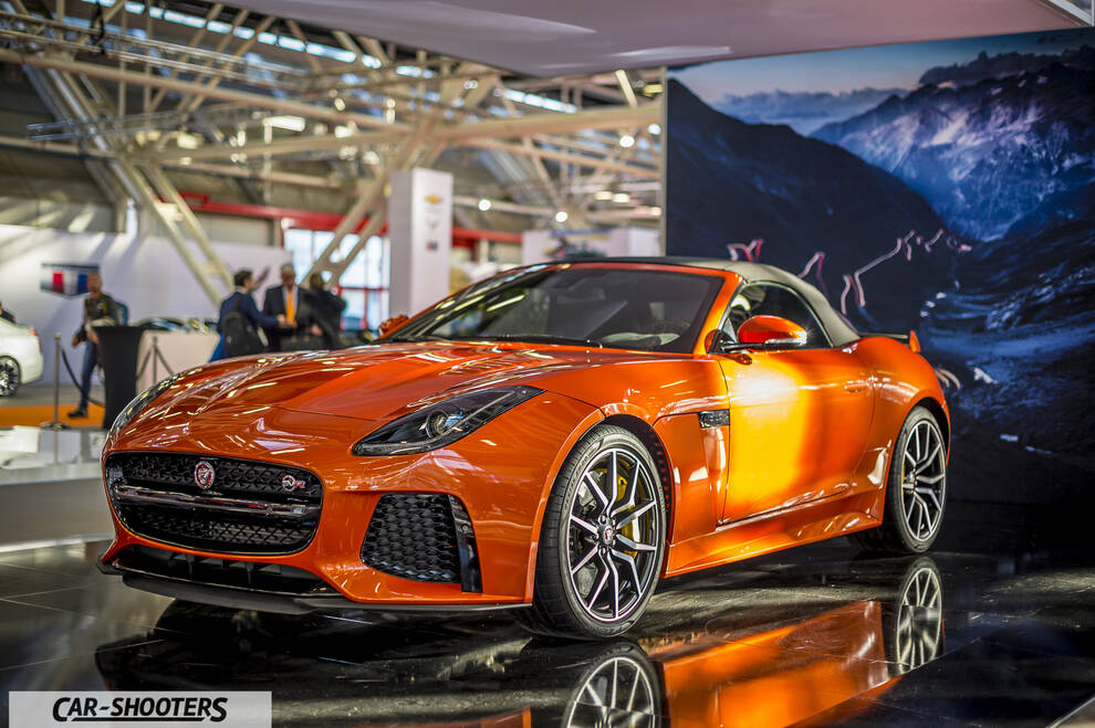 front three-quarter, bright orange at an indoor auto show