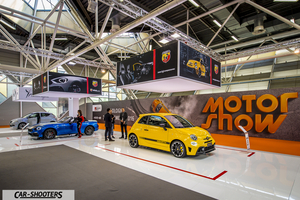 front three-quarter, yellow at an indoor motor show