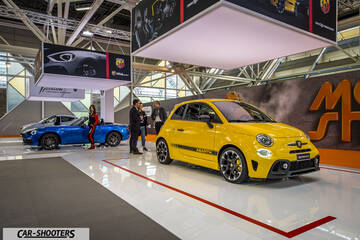 front three-quarter, yellow at a car show