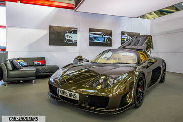 front three-quarter, bronze metallic in a showroom