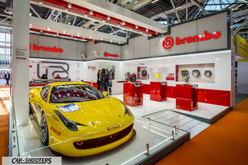front three-quarter, yellow at a trade show booth