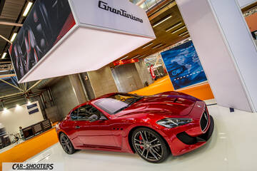 front three-quarter, red at an indoor auto show