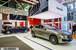 front three-quarter, silver metallic in an auto show exhibit