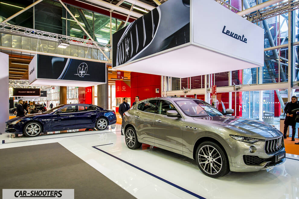 front three-quarter, silver metallic in an auto show exhibit