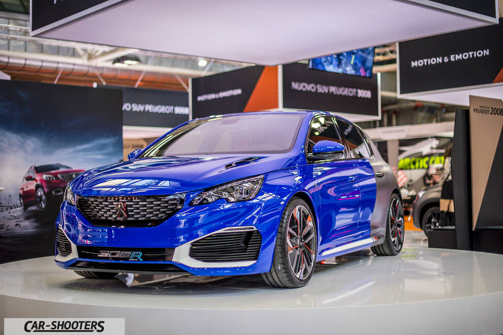 front three-quarter, blue and grey on a showroom stage