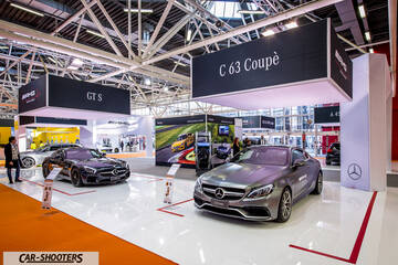 front three-quarter, grey metallic in an auto show exhibit
