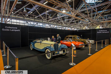 front three-quarter, blue and cream on display at an indoor exhibition