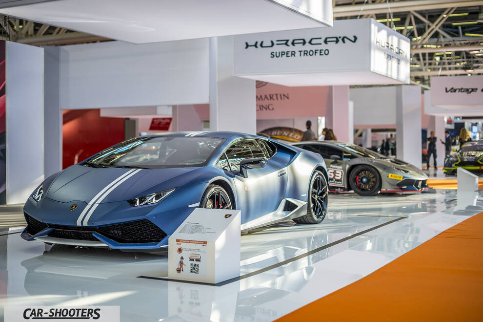 front three-quarter, matte blue at an indoor auto show