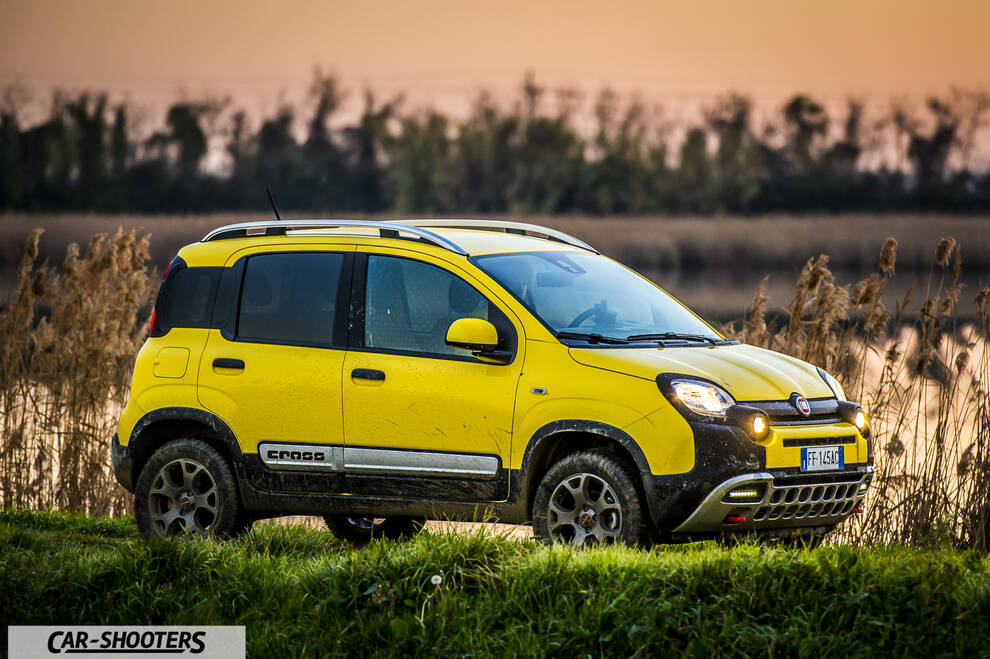 Fiat Panda 4X4 Cross – front three-quarter, yellow against a sunset marsh backdrop