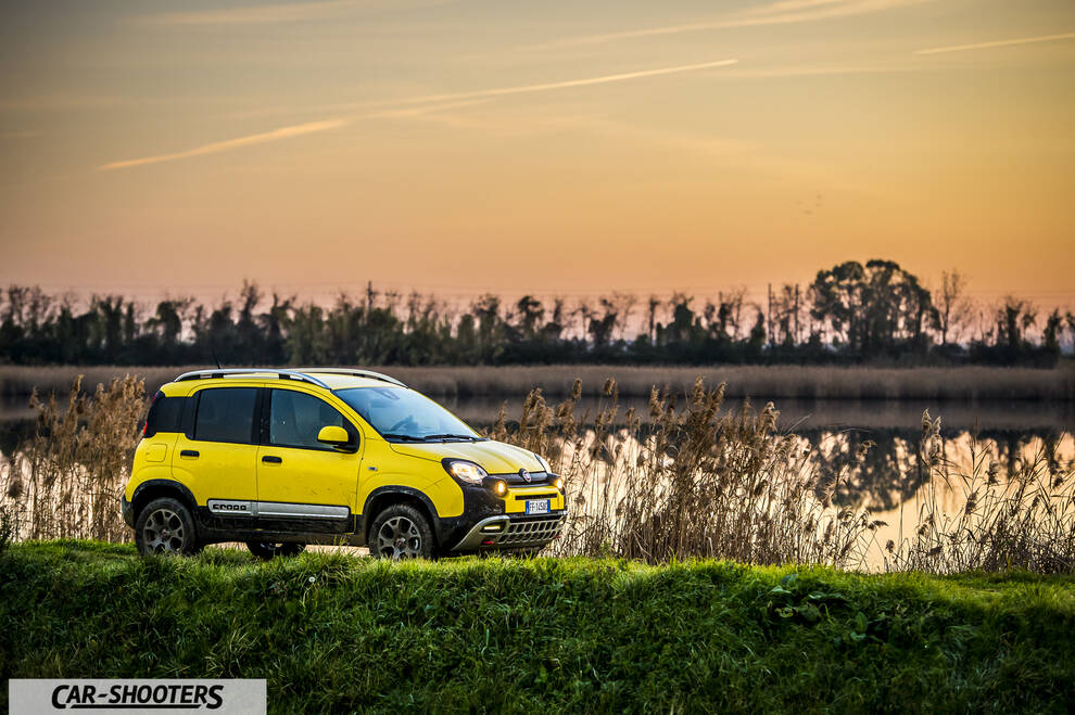 Fiat Panda 4X4 Cross – side profile, yellow against a sunset lake backdrop