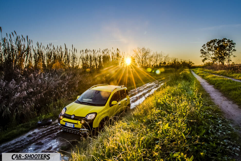 Fiat Panda 4X4 Cross – front three-quarter, yellow on a muddy path at sunset