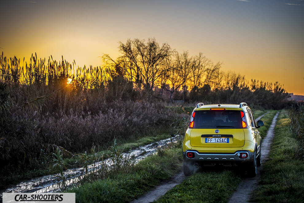Fiat Panda 4X4 Cross – rear view, yellow on a dirt path at sunset