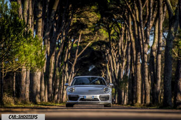 Porsche 911 Turbo S – front three-quarter, silver metallic on a tree lined road