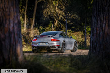 Porsche 911 Turbo S – rear three-quarter, silver on a country road