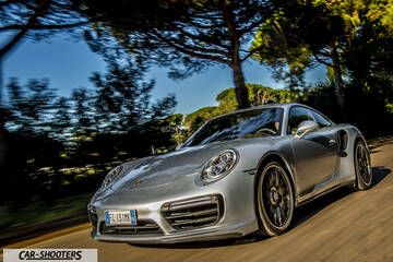 Porsche 911 Turbo S – front three-quarter, silver metallic on a country road