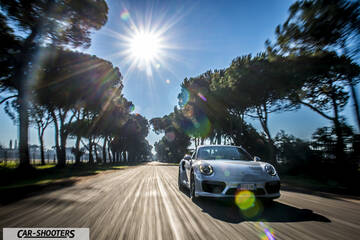 Porsche 911 Turbo S – front three-quarter, silver on a tree lined road