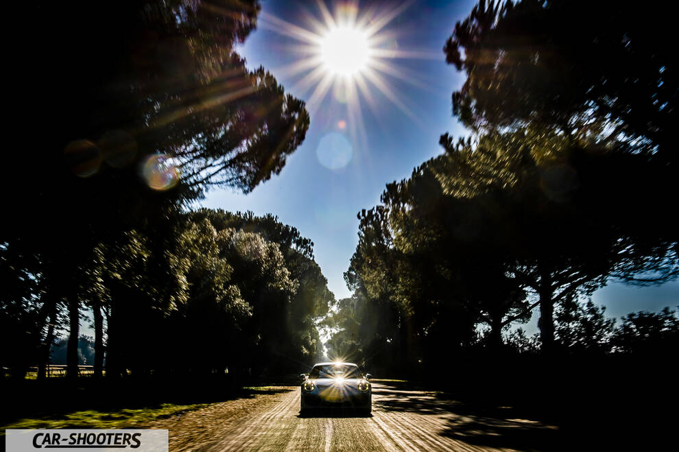 Porsche 911 Turbo S – front three-quarter, on a tree lined road
