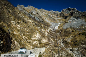 Alfa Romeo Giulietta Veloce – rear three-quarter, white against a mountain backdrop