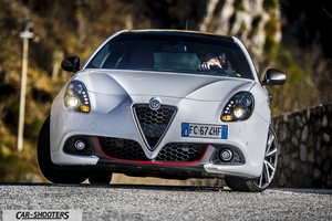 Alfa Romeo Giulietta Veloce – front three-quarter, white on a winding mountain road