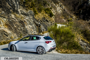 Alfa Romeo Giulietta Veloce – rear three-quarter, silver against a rocky mountain backdrop
