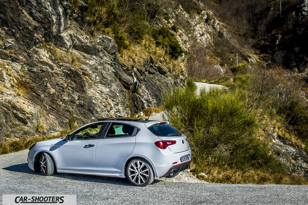 Alfa Romeo Giulietta Veloce – rear three-quarter, silver against a rocky mountain backdrop
