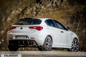 Alfa Romeo Giulietta Veloce – rear three-quarter, white against a mountain backdrop