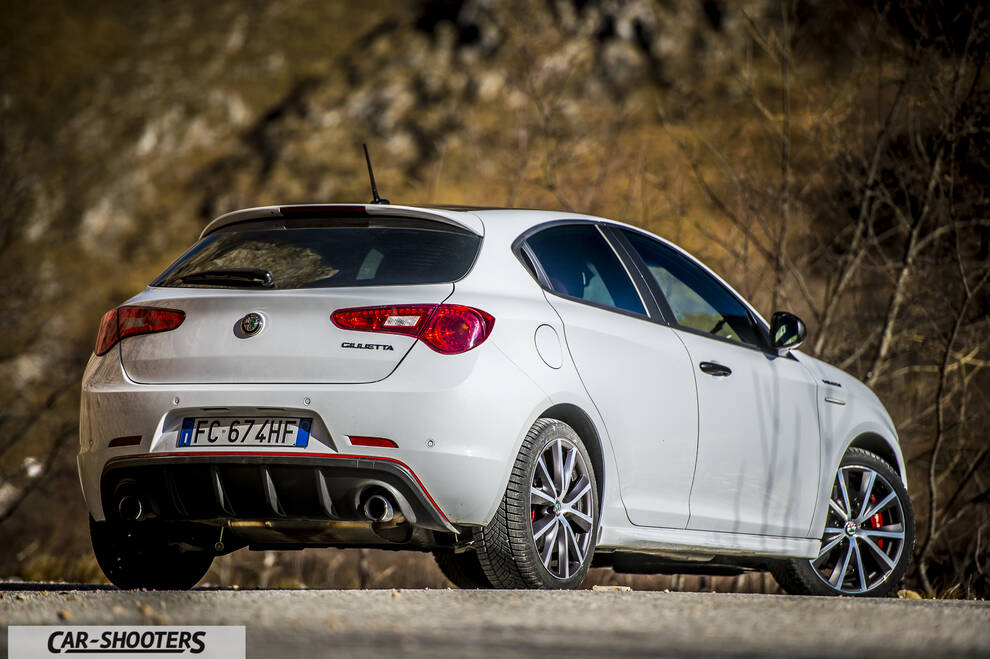 Alfa Romeo Giulietta Veloce – rear three-quarter, white against a mountain backdrop