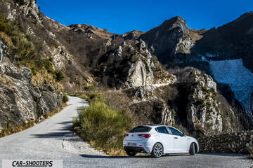Alfa Romeo Giulietta Veloce – rear three-quarter, white against a mountain backdrop