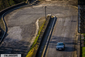 Toyota GT86 Namur – front three-quarter, dark grey on a winding uphill road